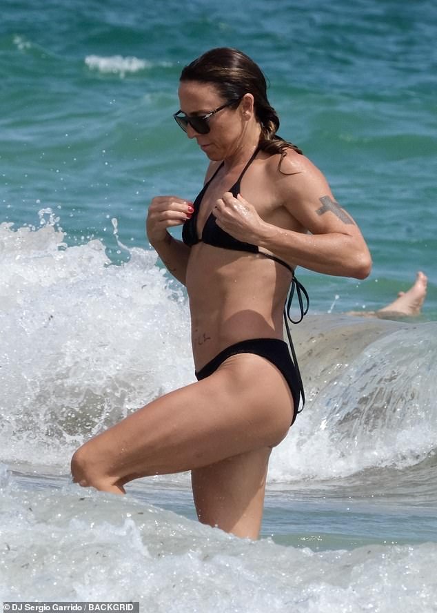 Mel was seen running out of the water as she tried to avoid being splashed by a wave.