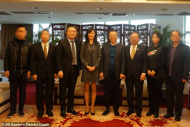 Sun poses with members of the All-China Federation of Returned Overseas Chinese (ACFROC) in further evidence presented by the US government.