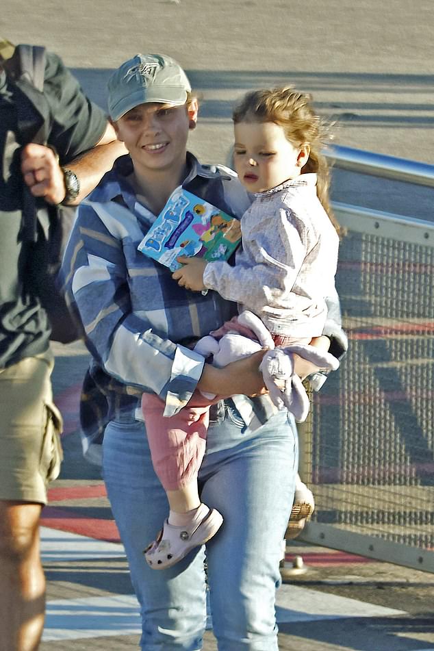 Bindi opted for comfort dressed in a casual checked shirt over a grey t-shirt, paired with light blue jeans and white sneakers.