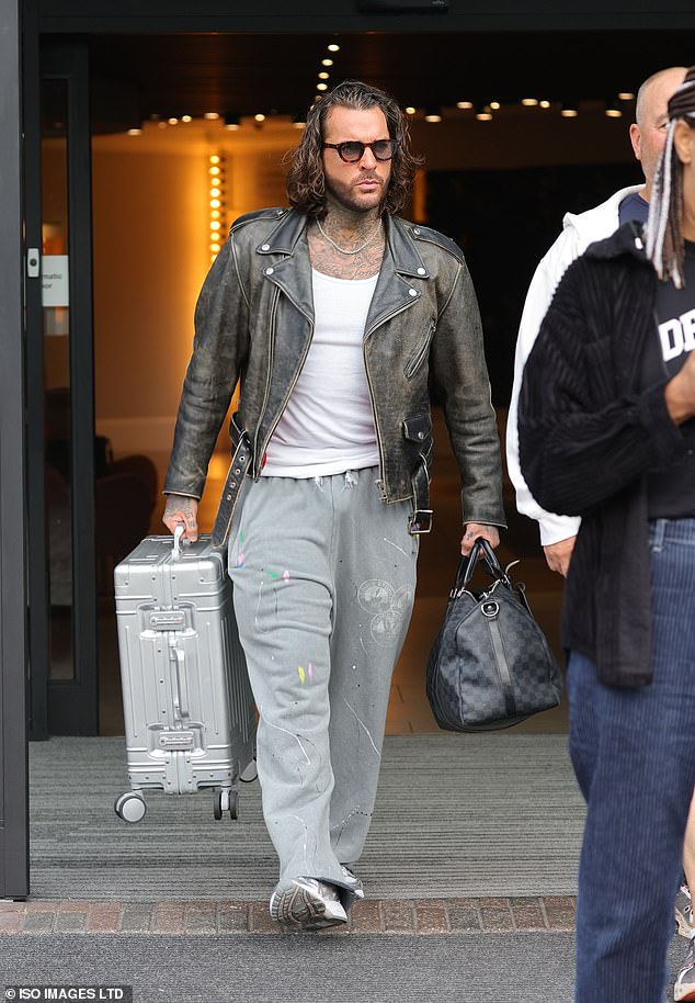 Pete Wicks, 36, donned a pair of paint-splattered grey trousers and a white T-shirt under a ripped black leather jacket as he carried two bags outside his London hotel.