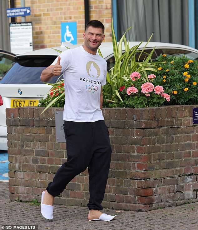 Aljaž Škorjanec looked cheerful as he arrived in a Paris Olympics T-shirt, giving a thumbs-up to photographers as he headed to the car still wearing his white hotel slippers.