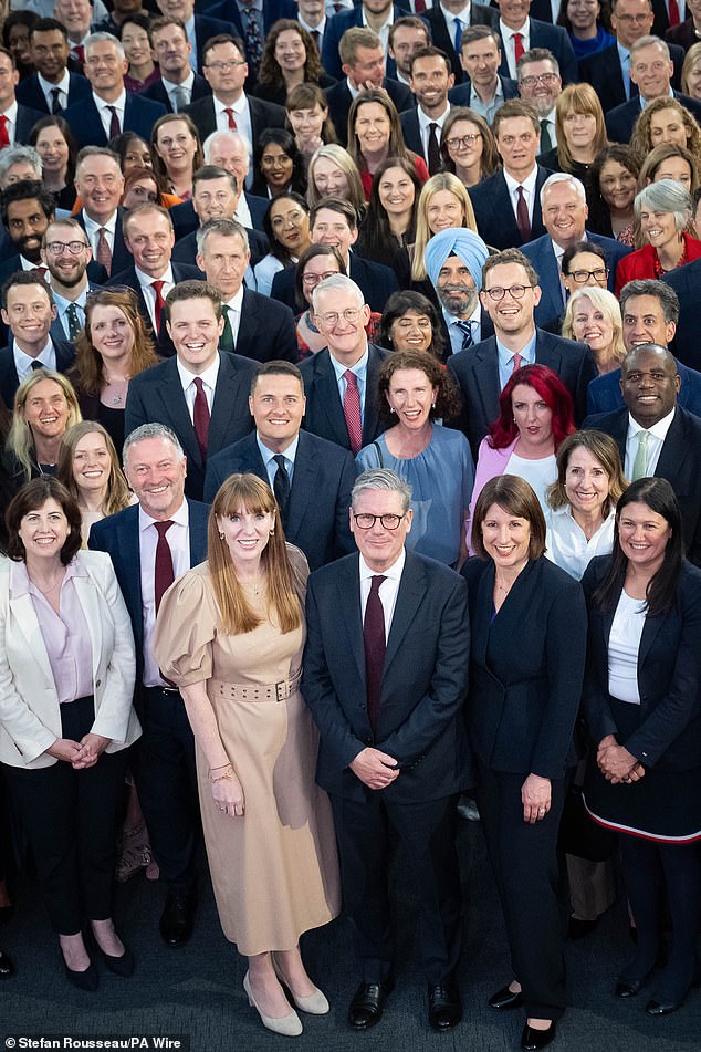 British Prime Minister Sir Keir Starmer is pictured with Labour MPs elected in a landslide victory on July 4. Now American politicians want a slice of his success.