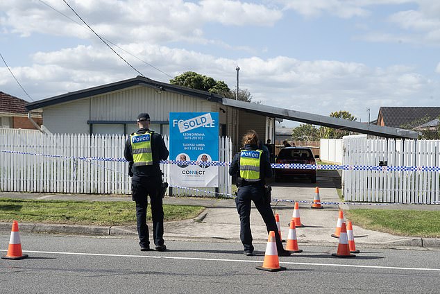 The baby was discovered in a critical condition on the driveway of a home in Dandenong North, south-east Melbourne, at 2.40am on Friday (pictured: police outside the home).