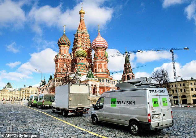 Broadcast vans of Russian state television Russia Today (RT) are seen parked in front of St Basil's Cathedral and the Kremlin, next to Red Square in Moscow.