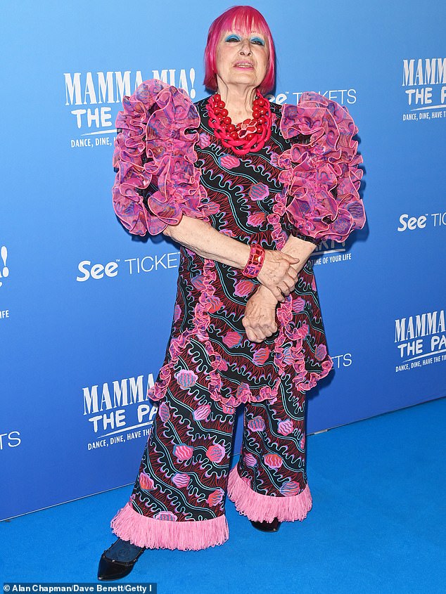 Fashion designer Dame Zandra Rhodes, 83, showed off her quirky style as she stepped out in a dramatic 80s-inspired outfit with ruffled sleeves and fringed trousers.