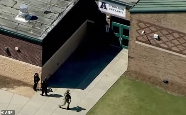 Pictured: Heavily armed police officers were seen entering the school on Wednesday morning.