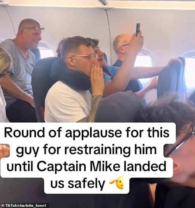 Reliving the incident, a source told The Sun: 'The cabin crew were brilliant and very brave but the whole drama was very upsetting (pictured: passengers cheering)