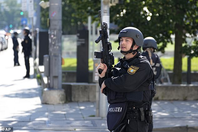 Police officers patrol near a scene after police shot a suspicious person near the Israeli Consulate and a museum about the city's Nazi-era history in Munich, Germany, Thursday, Sept. 5, 2024.