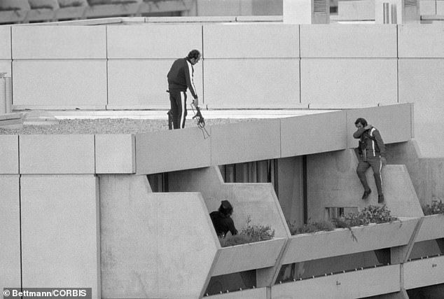 Armed police take up positions on a terrace just above the apartments where members of the Israeli Olympic team were being held hostage by the Black September group.