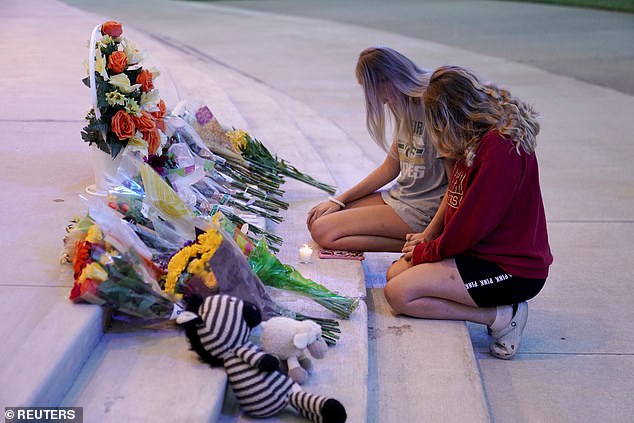 People attend a vigil at Jug Tavern Park following a shooting at Apalachee High School