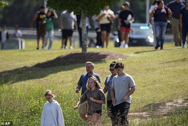 Students and parents leave the Apalachee High School campus, Wednesday, Sept. 4, 2024, in Winder.