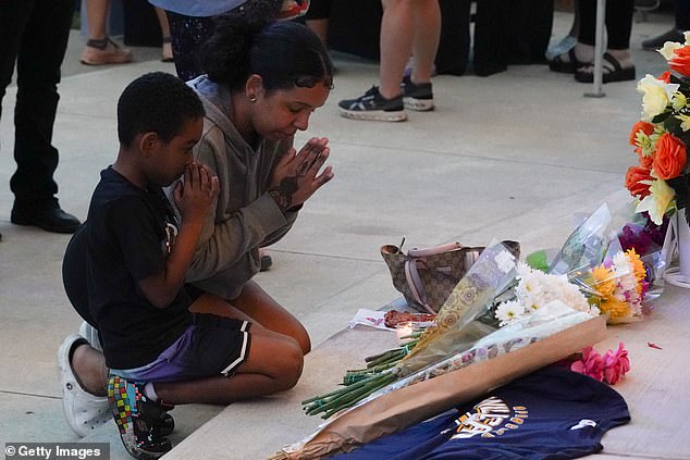 Students, teachers and community members gather for a vigil after a shooting at Apalachee High School