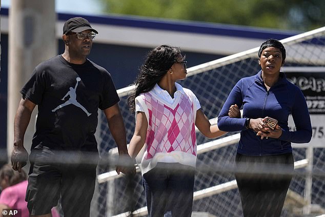 Parents escort their children out of Apalachee High School after a school shooting on Wednesday