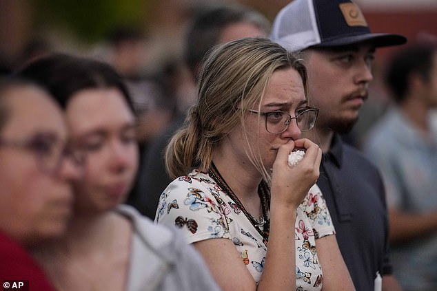 Mourners pray during a candlelight vigil for students and teachers killed at Apalachee High School