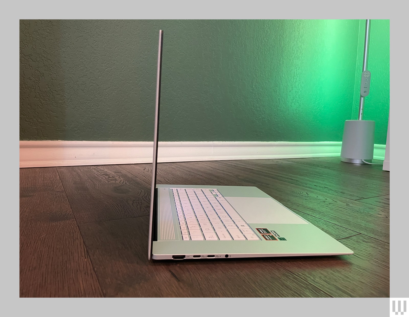 Side view of a slim silver laptop open at a 90 degree angle