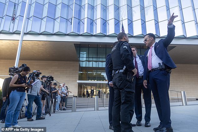 Law enforcement officers and reporters gathered outside the U.S. Courthouse as Hunter arrived at the Los Angeles courthouse.