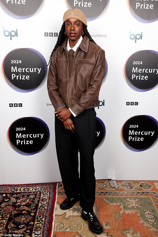 Cat, 24, looked dapper in a brown leather jacket, paired with a smart white shirt, a tie and a matching beret.