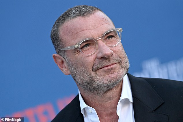 Greer's husband, Tag (Liev Schreiber), practices his golf swing by hitting balls into the ocean, aiming for seagulls, while smoking a joint.