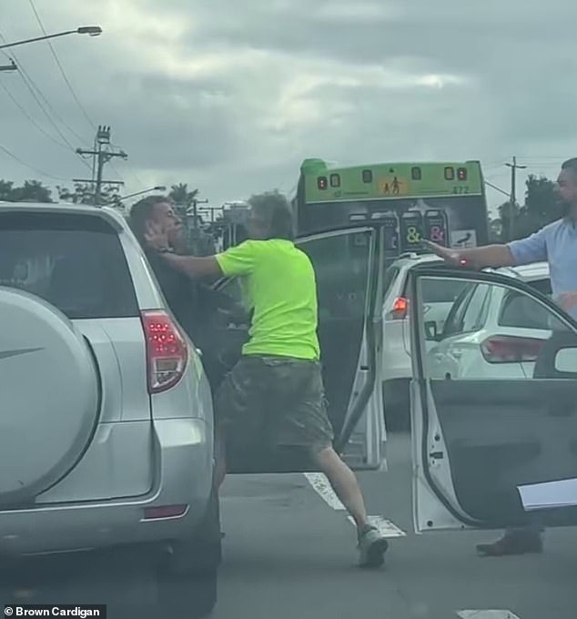 At one point, the man in the high-vis vehicle pinned the other man against the 4x4 vehicle before several bystanders intervened (pictured)