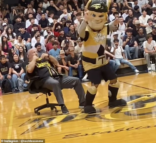 The students seemed amused when the mascot made a pinching gesture at Nunes' face as the music played.