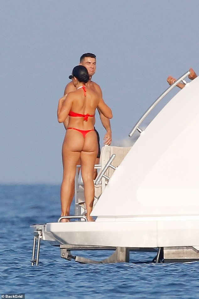 Georgina looked sensational as she flaunted her enviable hourglass figure in a red thong bikini.