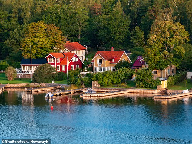 Many of the red-roofed cottages found in the archipelago (above) are summer retreats owned by locals, reveals Rob