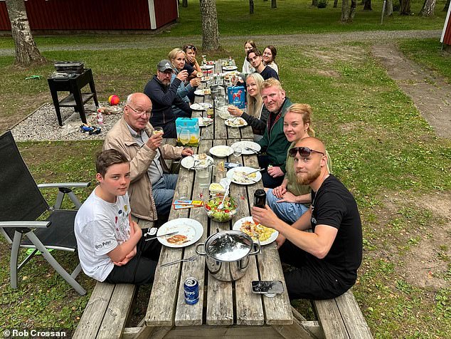 Rob and his group, members of his partner Emma's Swedish family, enjoy lunch on their doorstep. 