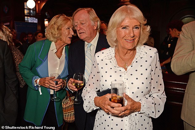 Royal sister Annabel Elliot chats to Andrew Parker Bowles as a beaming Queen Camilla poses for a photograph.