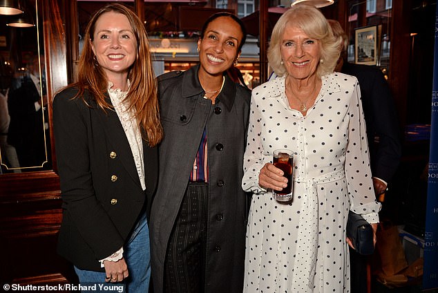 Camilla (pictured with Louisa, left, and Chioma Nnadi, right) was beaming as she proudly attended the occasion, looking radiant in a monochrome polka dot maxi dress.