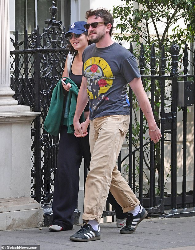 Paul sported a 'Guns 'N' Roses' graphic tee, paired with beige chinos and trendy Adidas trainers.