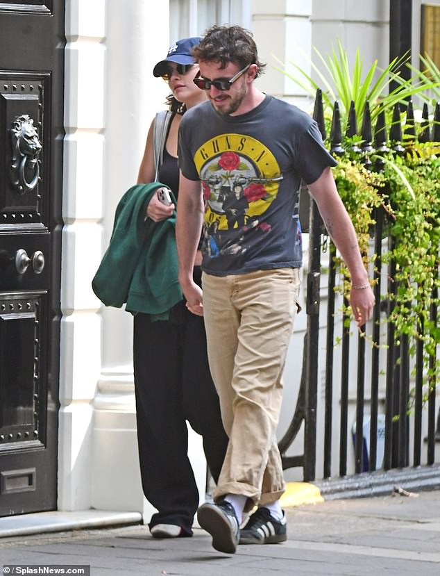 His gorgeous girlfriend Gracie rocked a casual look in baggy trousers and showed off her midriff in a spaghetti strap crop top.