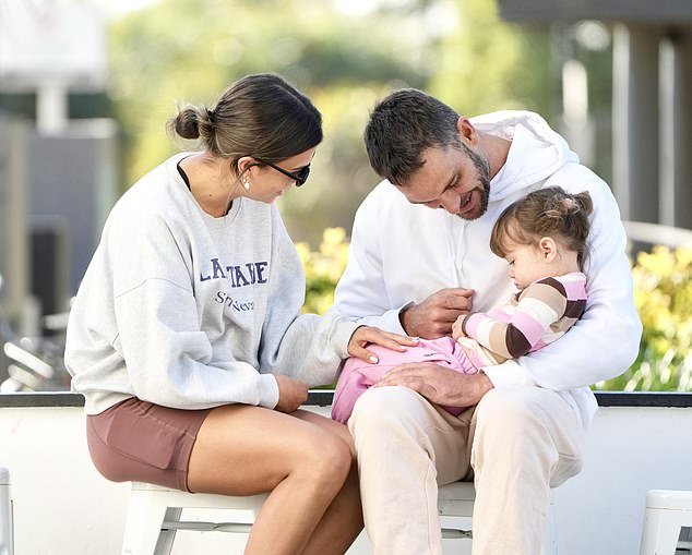 The couple shared a tender moment with the little one.