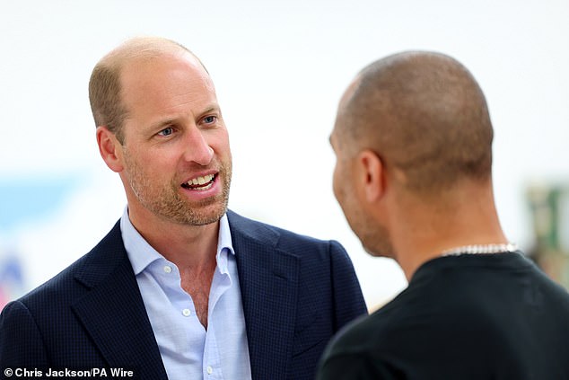 Prince William talks to an artist during a visit to the Saatchi Gallery in London yesterday