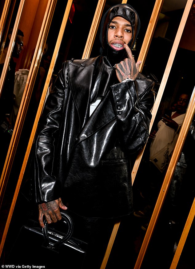 American rapper NLE Choppa, 21, looked cool in an all-black leather outfit, including a mask and a briefcase-style bag.