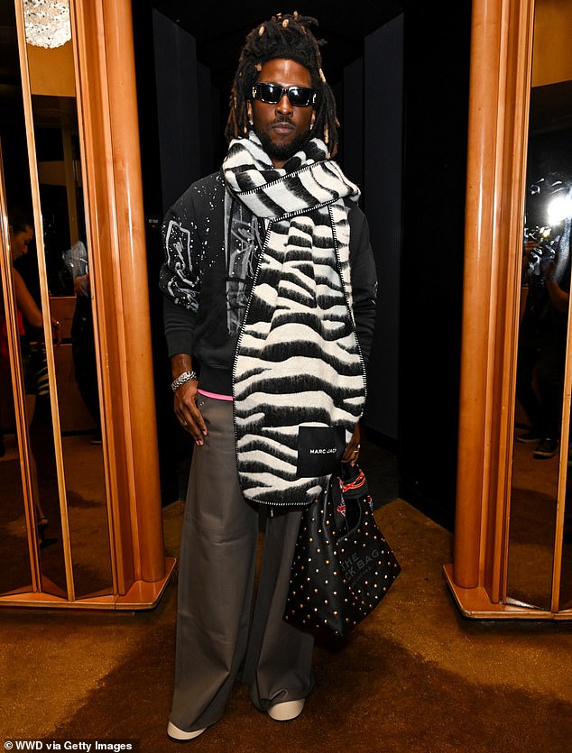 Guyanese-American SAINt JHN, 38, looked great in an oversized zebra-print scarf and baggy grey pants.