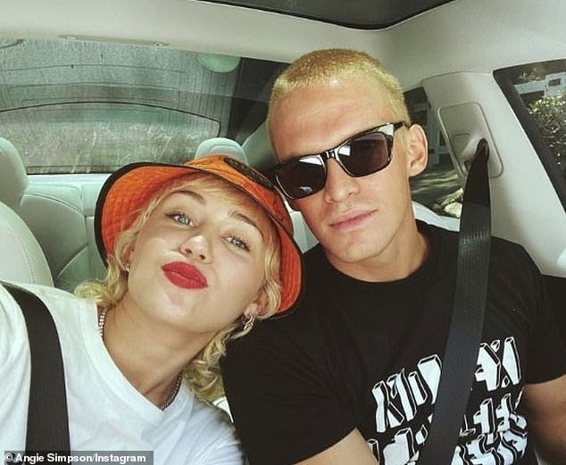 Miley and Cody dated while he was living in the US and split after 10 months together in August 2020. They both appear in the photo.