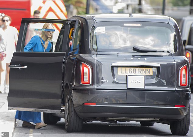 Gabriella chatted with the black cab driver before opening the door and getting into the cab.