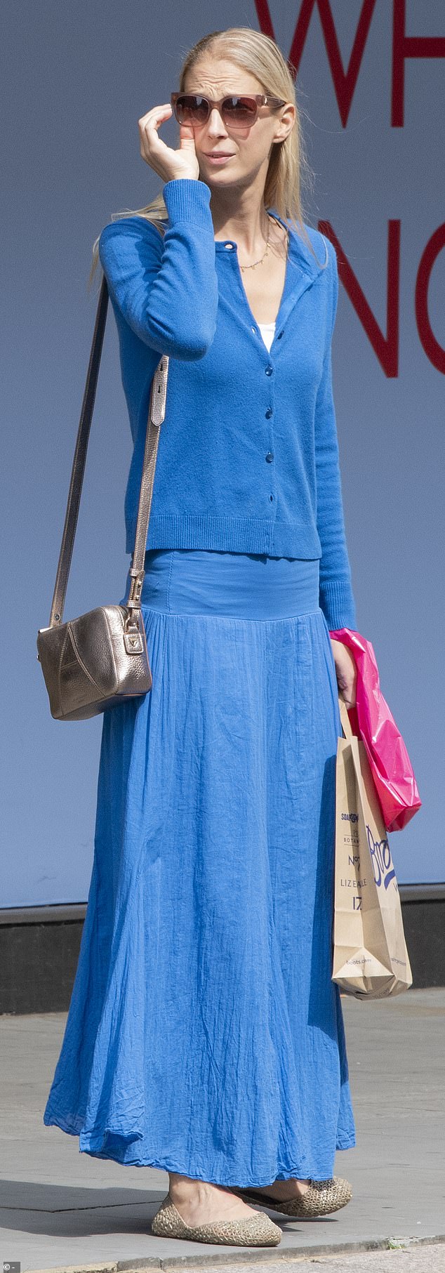 The 43-year-old looked stylish in her vibrant outfit, as she stood on the sidewalk holding her sunglasses.