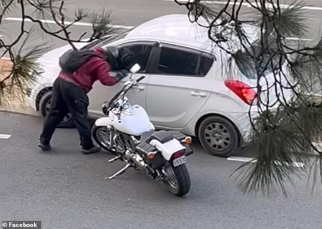 The motorcyclist headbutted the passenger side window of the car hard but failed to break it in the shocking encounter this week.