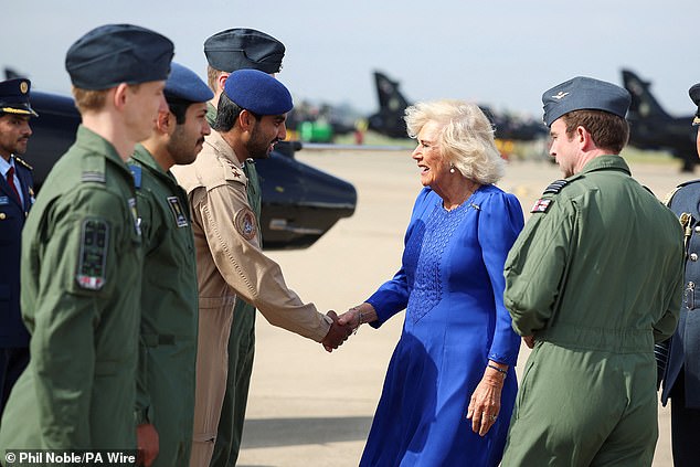 Queen Camilla, who was an honorary air commodore, shook hands with a pilot from the Emir of Qatar's Air Force.