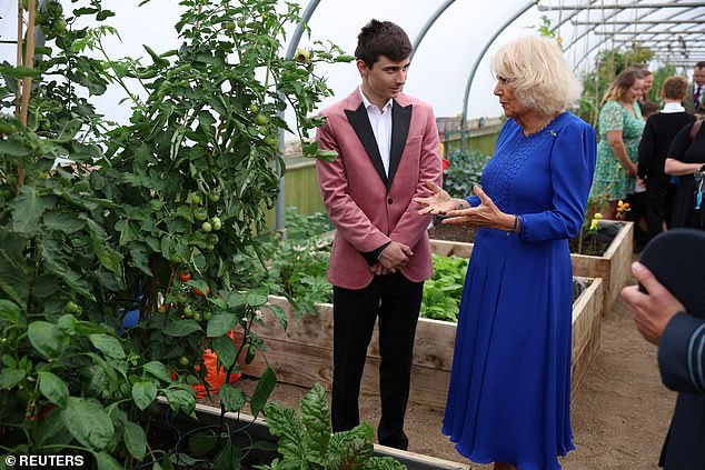 Camilla, pictured, met another volunteer in the orchard during her visit to RAF Leeming.