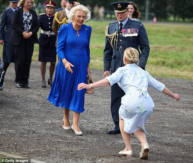 A woman curtsied to Camilla as she arrived at the orchard. The royals pictured during their visit