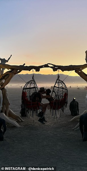 Danica Patrick on a swing at Burning Man