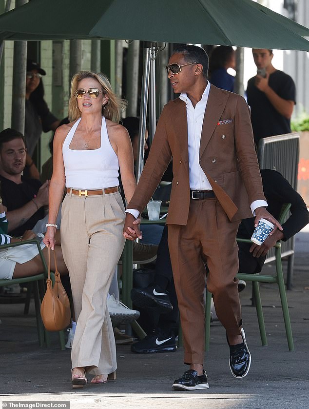 Amy wore a white halterneck top, beige dress pants, a brown Hermes belt, and heels, matching TJ's brown suit.