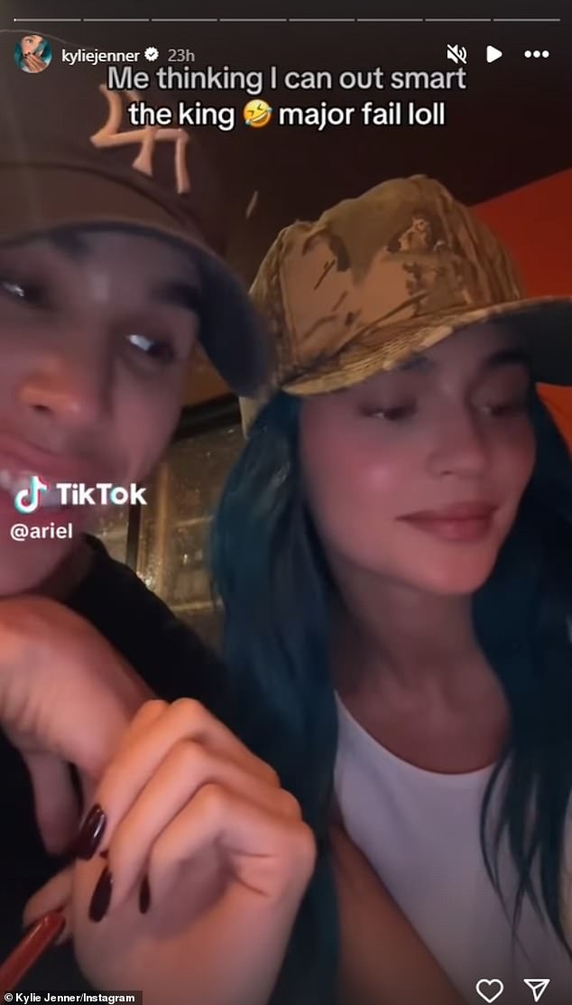 In a short video clip Kylie shared on social media, she can be seen sporting a camouflage hat over her blue hair while chatting with a friend.