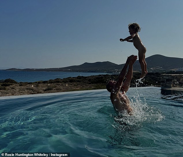 She posted this rare vacation snap of her fiancé Jason and their 2-year-old daughter Isabella on Friday.