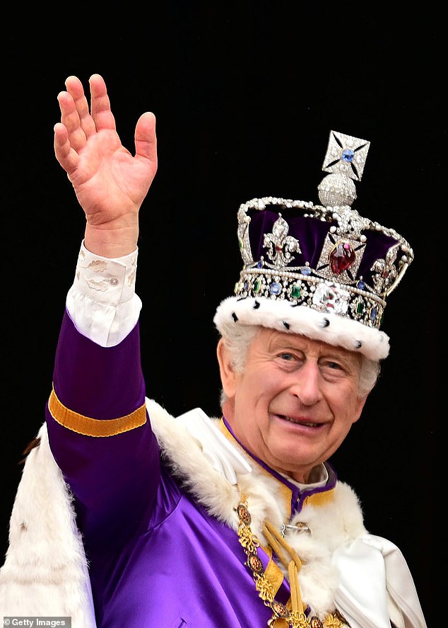 King Charles III waves from the balcony of Buckingham Palace after the coronation service in May last year.