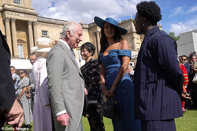 King Charles III speaks to Maya Jama and Campbell Addy at The Sovereign's Creative Industries Garden Party at Buckingham Palace, May 15