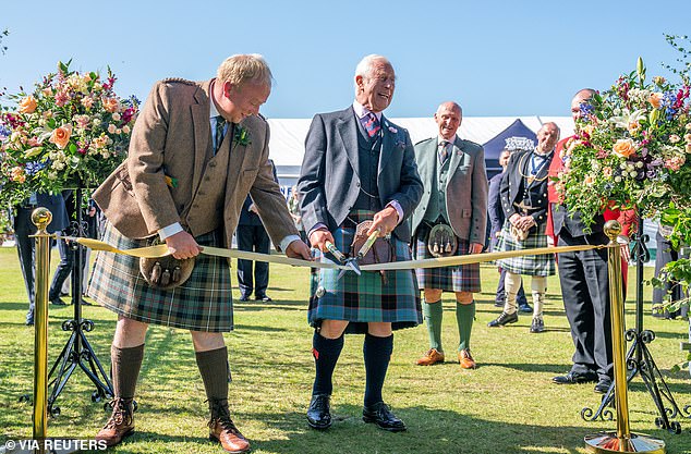 King Charles uses a pair of gardening shears to officially open the Royal Horticultural Society's 200th Flower Show in Aberdeen on August 31