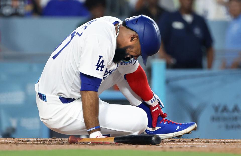 Teoscar Hernandez clutches his foot in agony after being hit by a pitch in the first inning Friday against the Guardians.